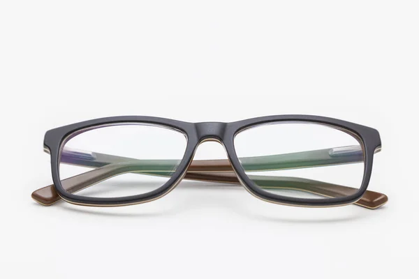 Pair Dark Rimmed Glasses Viewed Front Temples Crossed Placed White — Stock Photo, Image