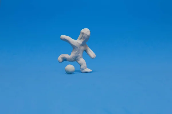 White Plasticine Doll Practicing Soccer Blue Background Doll Ready Kick — Stock Photo, Image