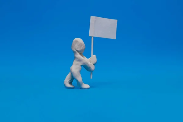 White Plasticine Dummy Carrying White Flag Blue Background Dummy Holds — Stock Photo, Image