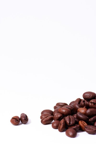 Lot of coffee beans in vertical white background
