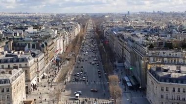 Fransa 'nın başkenti Paris' te Champs-Elysees Bulvarı 'nda trafiği taşıyorum. Klasik Fransız binaları ve mavi gökyüzü ile gökyüzü. Arabalar yolda gider, insanlar yürür. Sonbahar ya da kış zamanı