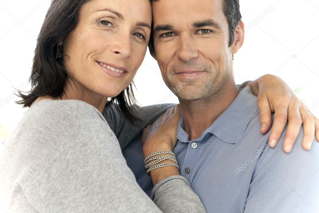 Close up Portrait of a mid adult couple hugging
