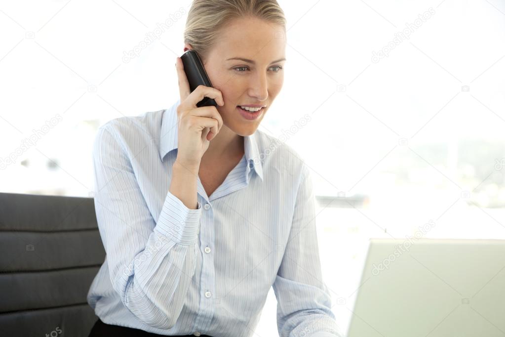 Beautiful young businesswoman on the phone