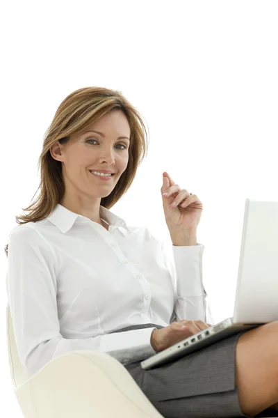 Businesswoman using laptop on knees — Stock Photo, Image