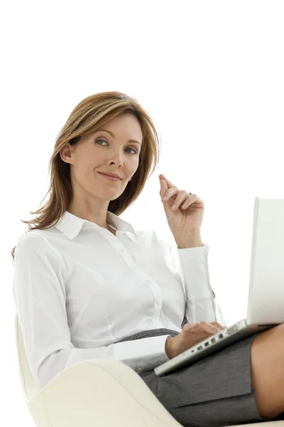 Businesswoman using laptop on knees — Stock Photo, Image