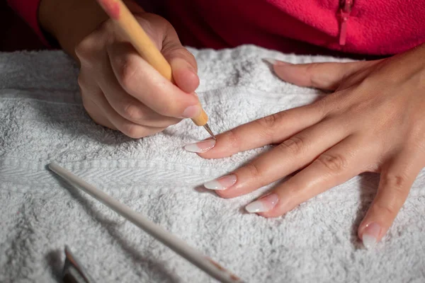 Gel nail process. Manicure concept. Beauty salon procedure.