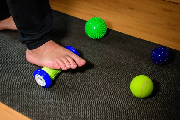 Man doing rehabilitation. Man doing rehabilitation on his foot after suffering a fracture. Man doing rehabilitation exercises at home.