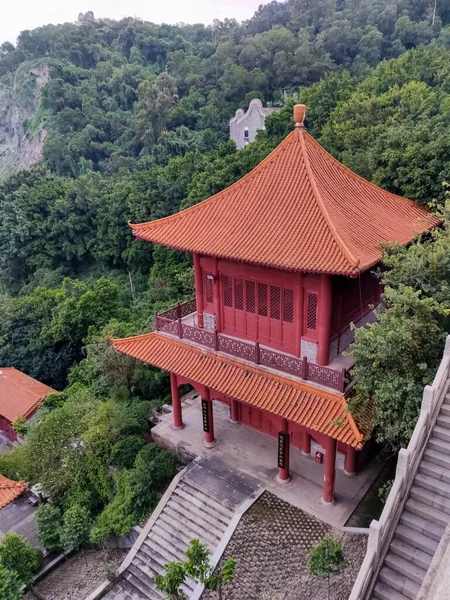 Asian style ancient pagoda building on a hillside among the trees