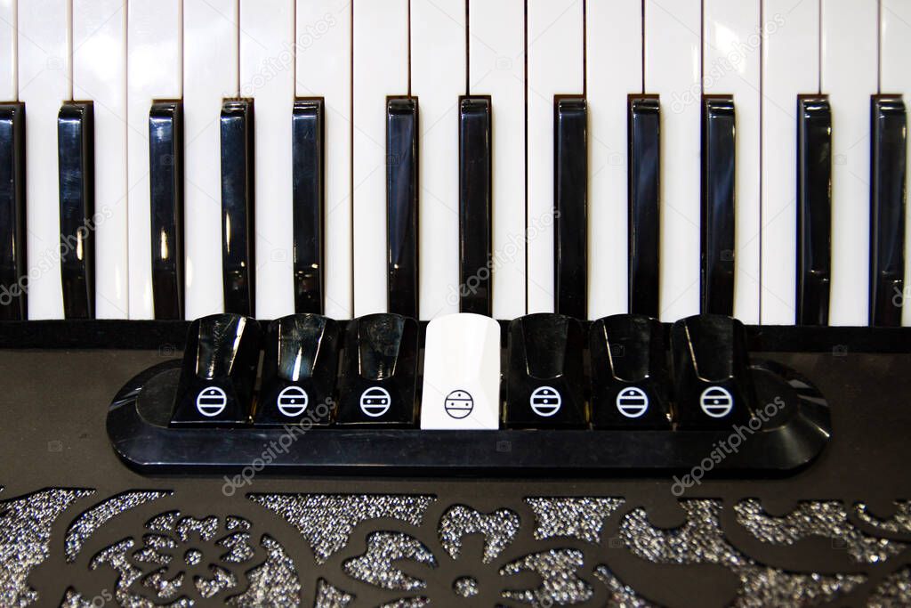 Close up of black and white keyboard of accordion, musical instrument, accordion keys