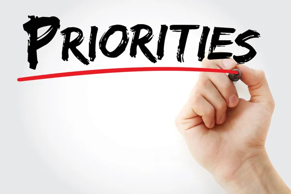 Hand writing Priorities with red marker — Stock Photo, Image