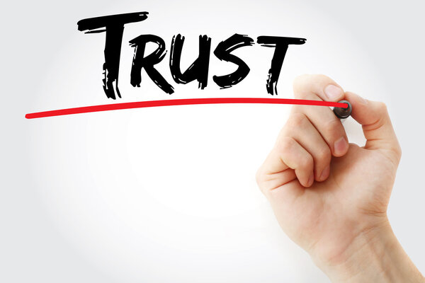 Hand writing Trust with marker