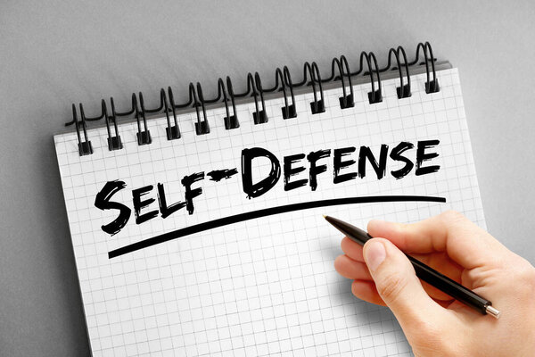 Self-defense text on notepad, concept background
