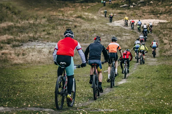 group of cyclists mountainbikers riding on a mountain