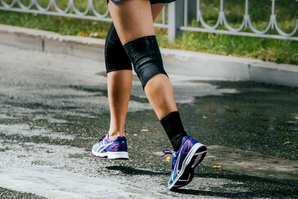 legs women athletes in knee pad running