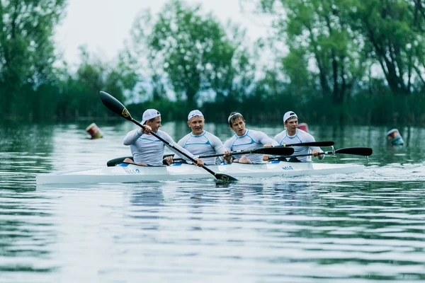 four athlete in a kayak