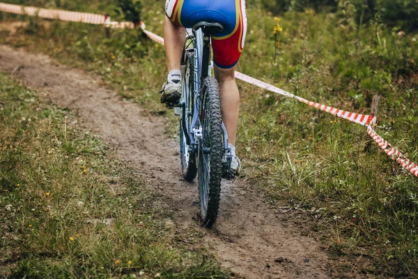 girl mountain bike rides on the trail