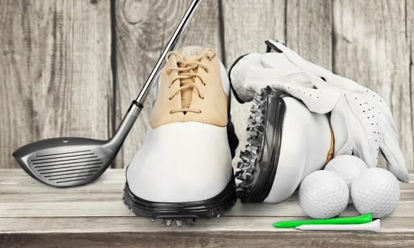 Pair of golfing shoes and a golf club — Stock Photo, Image