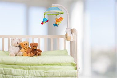 baby cot with toys clipart
