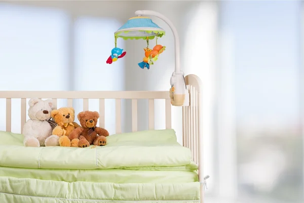 Baby cot with toys — Stock Photo, Image