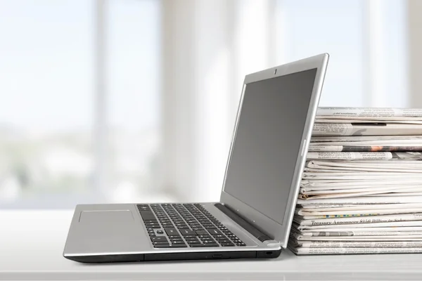 Newspapers on the laptop Isolated. — Stock Photo, Image