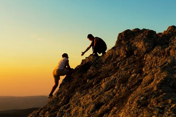 two men climbing on mountain