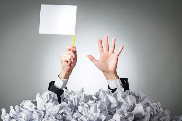 Businessman under crumpled pile of papers — Stock Photo, Image