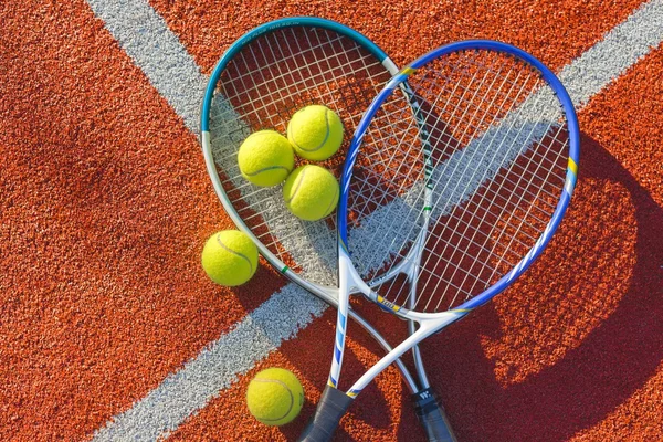Тенісні м'ячі та ракетки на фоні . — стокове фото