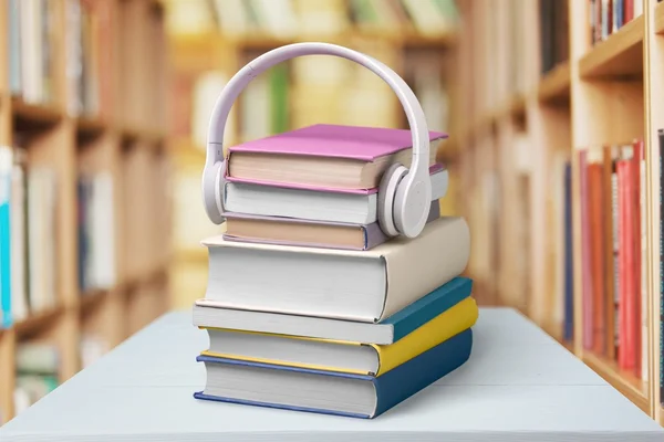 books and headphones on background