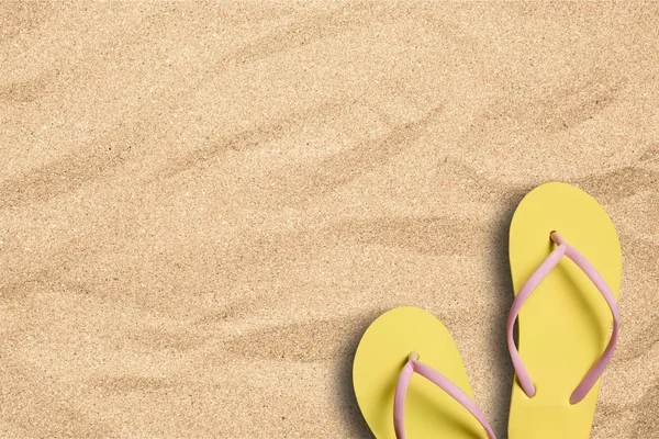 Background with a pair of    flip flops on beach — Stock Photo, Image