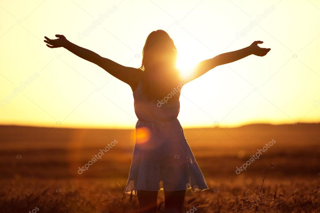 woman on field under sunset light