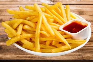 Fresh fried french fries with ketchup  clipart
