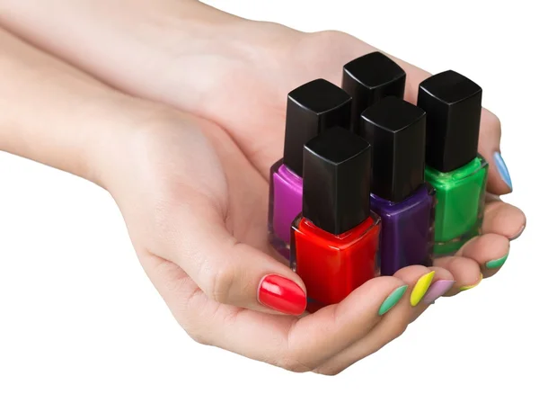 Manos de mujer sosteniendo esmaltes de uñas —  Fotos de Stock