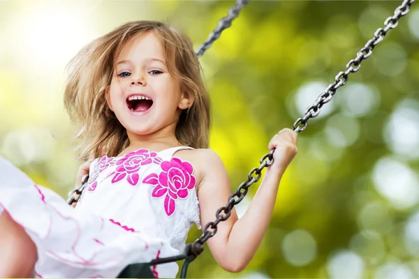 Little girl having fun on swing — Stock Photo, Image