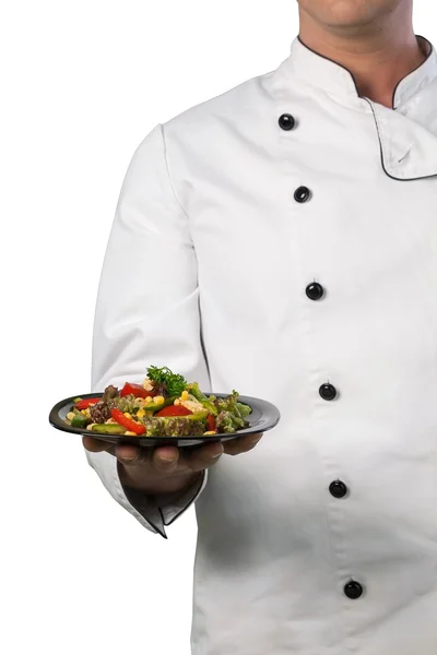 Шеф-повар держит тарелку с едой — стоковое фото