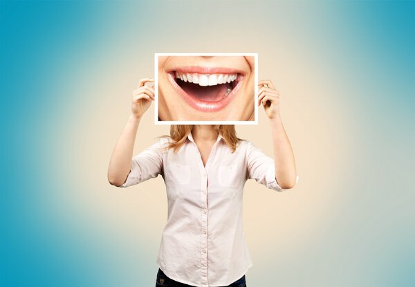 woman holding picture with big smile.