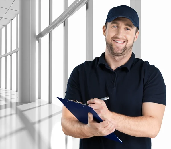 Delivery man with clipboard — Stock Photo, Image