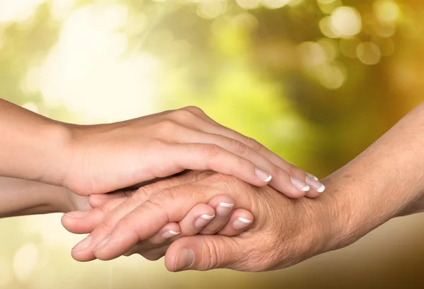 Hands of  old man and a young woman — Stock Photo, Image