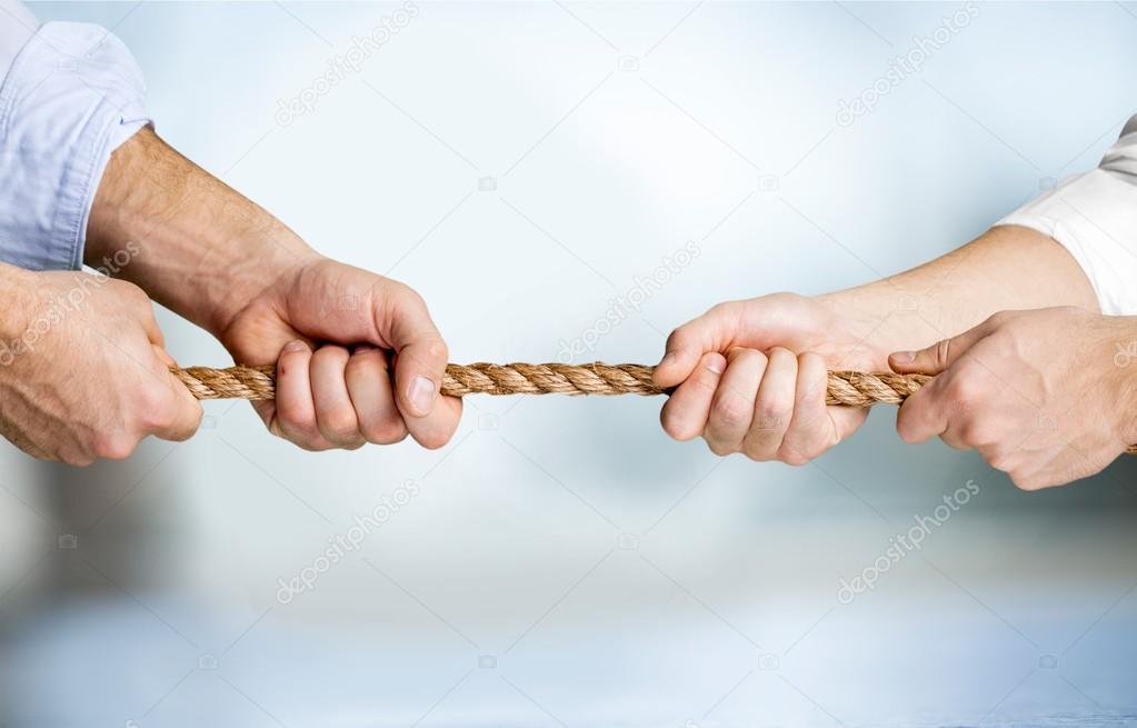 business people pulling rope