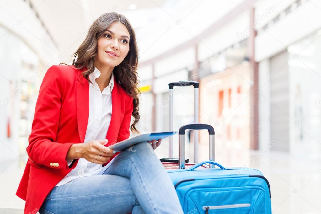 young woman with travel bags