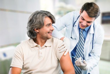 doctor making vaccination to patient clipart