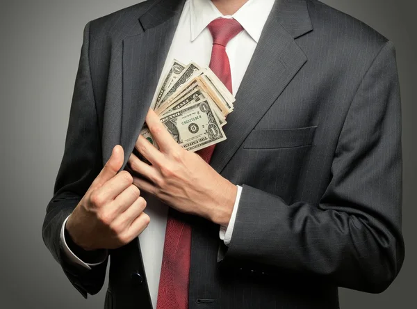 Businessman hiding dollars banknotes — Stock Photo, Image