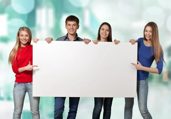 Students with blank sign — Stock Photo, Image