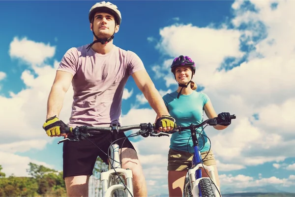 Happy couple riding bicycle outdoors — Stock Photo, Image