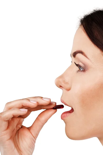 Woman taking a tablet — Stock Photo, Image