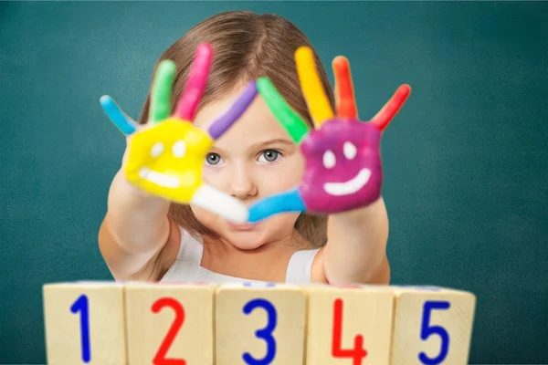 Маленька дівчинка з різнокольоровими розфарбованими руками — стокове фото