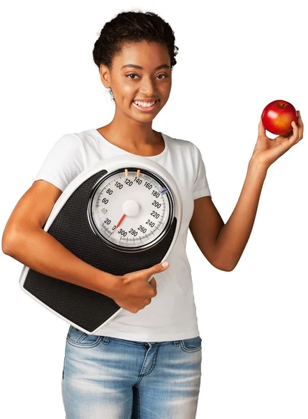 Piękna dziewczyna z jabłkiem i wagi mechaniczne — Zdjęcie stockowe