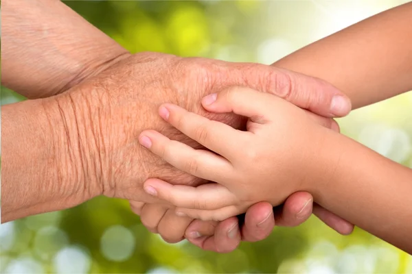Hands of young child and old senior — Stock Photo, Image