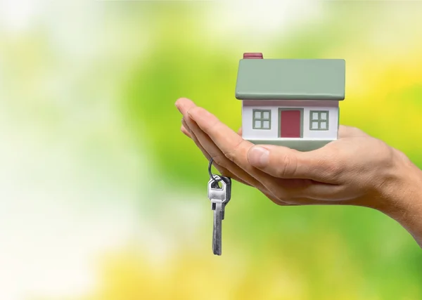 Zakenman holding house model — Stockfoto