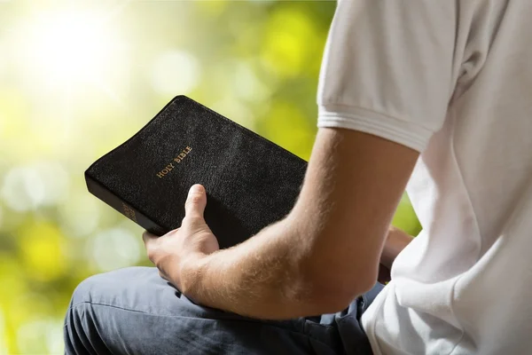 Man holding  bible book