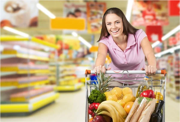 Woman with cart shopping Stock Picture